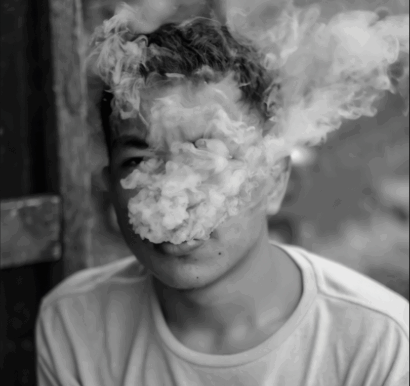 a person, identity covered by smoke